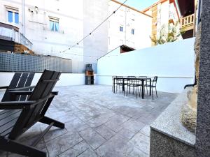 a patio with chairs and tables in a building at El Rincón de Santa Eufemia in Ourense
