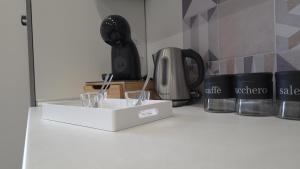 a white counter top with a coffee maker and glasses at Animo House in Pianillo +49 photos