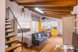 a living room with a couch and a kitchen at Aly d'Angelo alla Torre - Immobiliare Azzurra in Bardolino +24 photos
