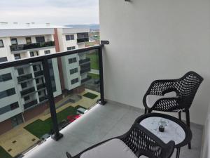 a balcony with two chairs and a table at Apartman Milos in Modriča