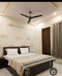 a bedroom with a bed with a ceiling fan at Fng Guest House in Noida
