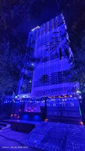 a building covered in blue lights at night at Fng Guest House in Noida
