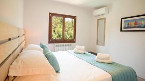 a bedroom with a large bed with two pillows on it at Mallorca Soller Port Villa High end Balearics in Port de Soller +31 photos