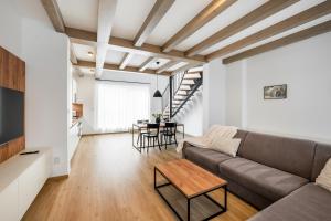 a living room with a couch and a table at Apartmány Lošov in Olomouc