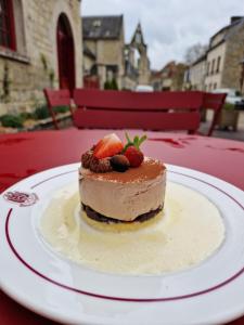 a piece of dessert on a plate on a table at HOTEL DE L'ABBAYE DE LONGPONT in Longpont +30 photos