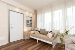 a living room with a couch in front of a window at Palazzo Mazzini in Cornaredo