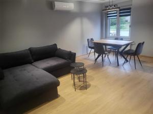 a living room with a couch and a table at Noclegi Bielawa in Bielawa