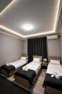 two beds in a hotel room with two at Hotel Madera in Tashkent +9 photos