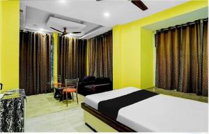 a bedroom with a bed and a desk and a chair at Harsh-Regency in Rānchī +26 photos