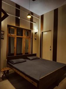 a bedroom with a large bed in a room at Amritganga Homestay in Uttarkāshi +18 photos