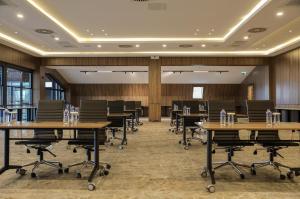 a conference room with wooden walls and tables and chairs at Wellwood Otel in Sapanca +68 photos