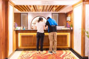 a man and a woman standing at a bar at Tulsi Kathmandu Hotel in Kathmandu +85 photos