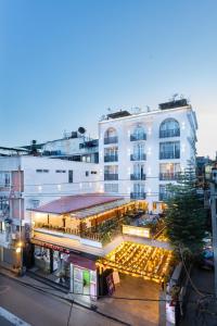 a large white building with lights in front of it at Tulsi Kathmandu Hotel in Kathmandu