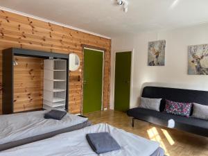 a living room with two beds and a couch at Hook&Cup in Sorsele