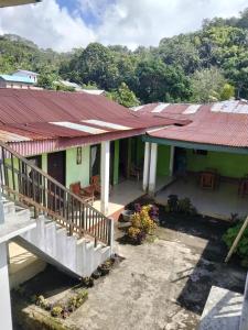a house with a red roof and a balcony at Irene in Kelimutu +8 photos