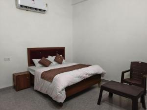 a bedroom with a bed with a tv on the wall at Sivago hotel in Kosi