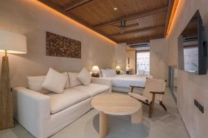 a living room with a couch and two beds at Peace House Koh Phi Phi in Phi Phi Islands
