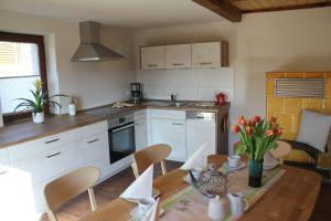 a kitchen with a table and a dining room at Ferienhof Leuner Sandro in Bad Schandau