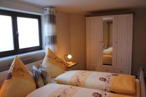 a bedroom with two beds and a mirror at Ferienhof Leuner Sandro in Bad Schandau +10 photos