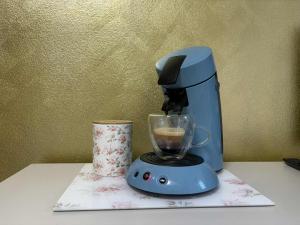 a blue blender sitting on a counter with a cup at APT 16 Telgart in Telgárt