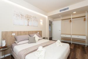 a bedroom with two beds with white sheets at Palazzo Mazzini in Cornaredo