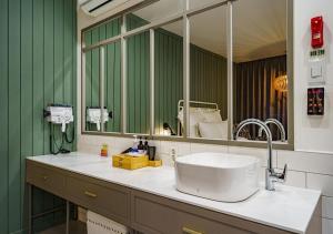 a bathroom with a sink and a large mirror at Browndot Hotel Daegu Exco branch in Daegu +61 photos