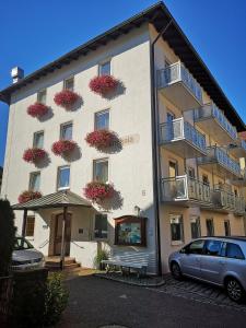 a building with flower boxes on the side of it at Hotel Germania in Bad Wörishofen