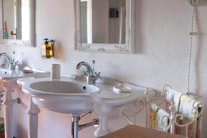a bathroom with a white sink and a mirror at Casa Torre Adults Only storia e relax a Fiorenzuola in Fiorenzuola di Focara +23 photos