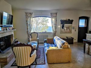 a living room with a couch and chairs and a fireplace at Casa degli Angeli in Fermo