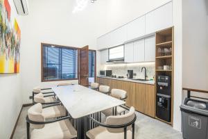 a kitchen and dining room with a table and chairs at Modern 2BR Villa Samudra Ocean View Nusa Dua in Ungasan