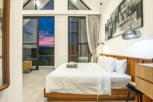 a bedroom with a bed and a large window at Modern 2BR Villa Samudra Ocean View Nusa Dua in Ungasan +89 photos