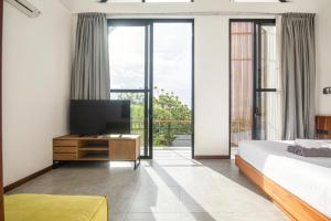 a bedroom with a large bed and a television at Modern 2BR Villa Samudra Ocean View Nusa Dua in Ungasan