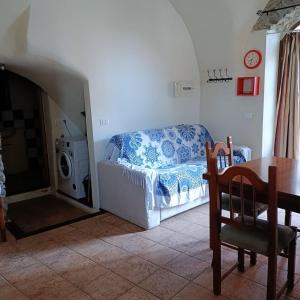 a living room with a bed and a table and a dining room at Ginestra in Cipressa
