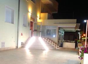 a group of stairs in front of a building at night at Appartamento Premier in Gatteo a Mare