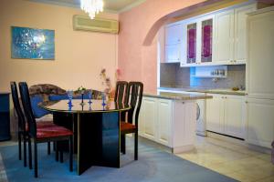 a kitchen with a table and chairs in a room at Apartment Elegance in Stara Zagora