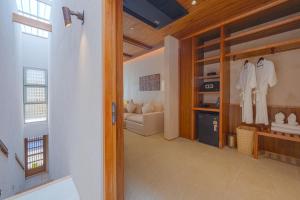 a hallway with a living room with a couch at Peace House Koh Phi Phi in Phi Phi Islands