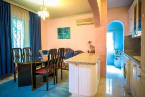 a kitchen and dining room with a table and chairs at Apartment Elegance in Stara Zagora