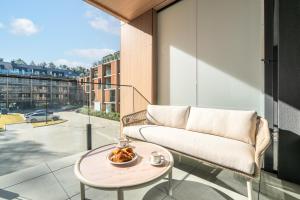 a living room with a couch and a table at Your Holidays Forest D141 in Międzyzdroje