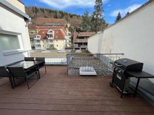 a balcony with a grill and chairs on a building at City Centre Terrace Apartment in Triberg