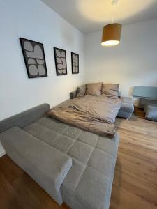 a large bed in a living room with a couch at City Centre Terrace Apartment in Triberg