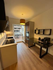a kitchen with a sink and a table in a room at City Centre Terrace Apartment in Triberg +14 photos
