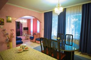 a dining room with a table and chairs and a living room at Apartment Elegance in Stara Zagora