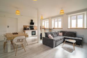 a living room with a couch and a table at Le Cocon Alsacien - Rez de chaussée - Parking privé in Ebersheim