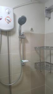 a shower in a bathroom with a shower head at Suntrust Parkview Apartment in Manila +14 photos
