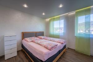 a bedroom with a bed and a large window at Müller´s Talblick in Deggingen