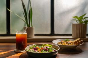 a table with two bowls of food and a drink at Minimalist One Hauz Khas Village in New Delhi