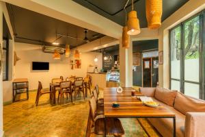 a living room with a couch and a table at Minimalist One Hauz Khas Village in New Delhi +76 photos