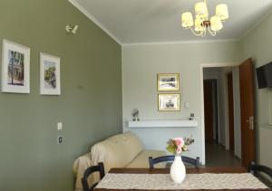 a living room with a table and a couch at Portico Cozy Home in Kariá