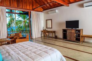 a bedroom with a bed and a flat screen tv at R Degrees in Ambalangoda