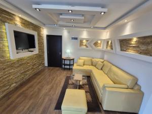 a living room with a couch and a flat screen tv at Panorama Apartment in Belgrade